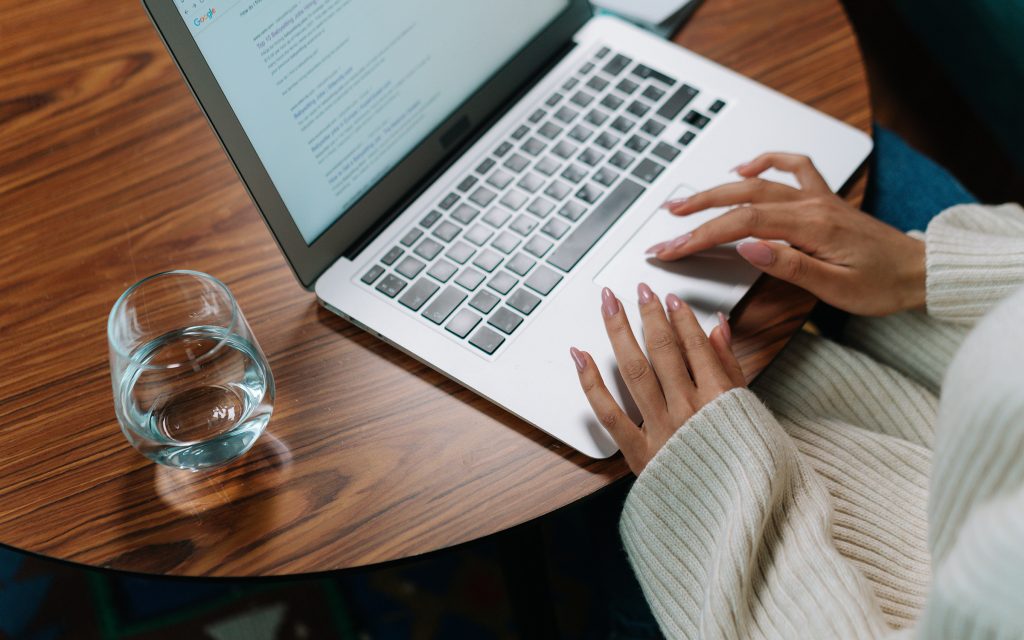 office worker working on laptop with microsoft word and excel